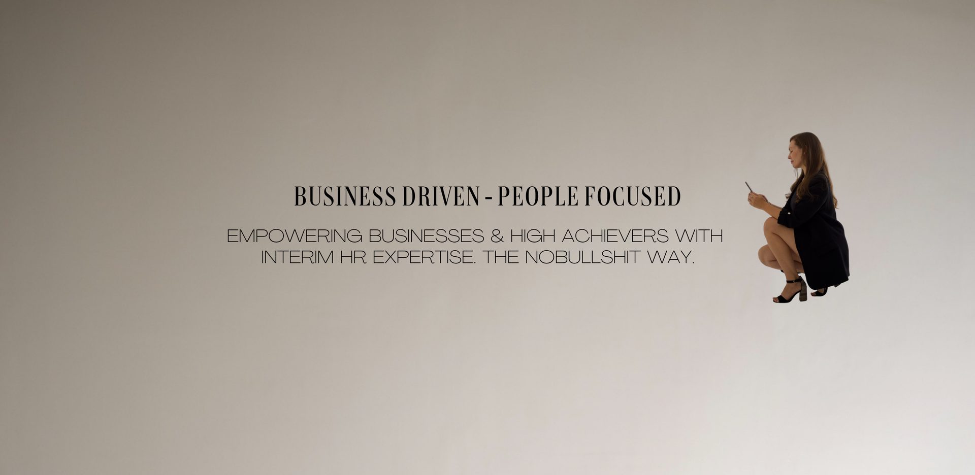 Business driven – people focused. Empowering businesses & high achievers with interim HR expertise. The no-bullshit way. Denise in black, crouching, phone in hand.